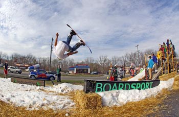 snowboarding front flip at outdoor action company railjam